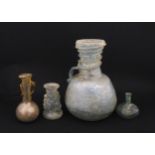 Four glass vases in the Roman style with iridescent finish, some with trail detail. Largest