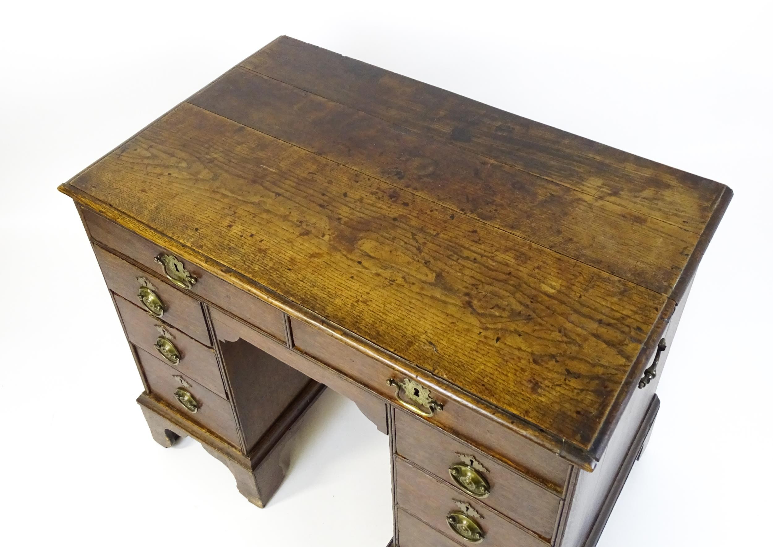 An early / mid 18thC oak kneehole desk with a moulded top above two short drawers and two banks of - Image 7 of 10