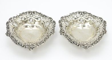 A pair of Victorian silver bon bon dishes of heart form with pierced and foliate decoration