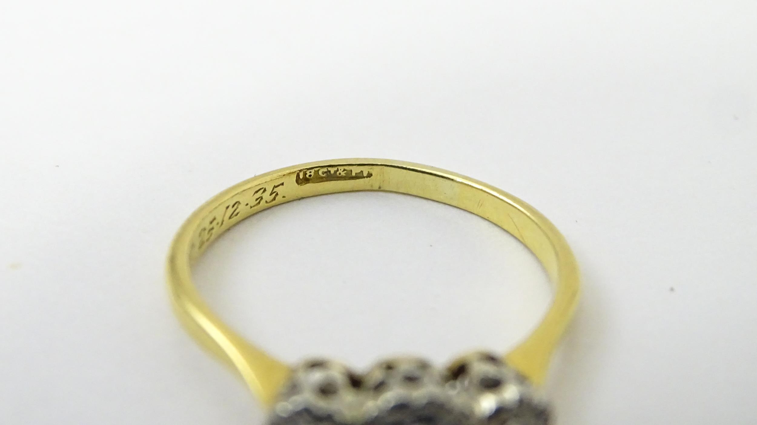 An 18ct gold ring with three platinum set diamonds. Ring size approx. O Please Note - we do not make - Image 17 of 18