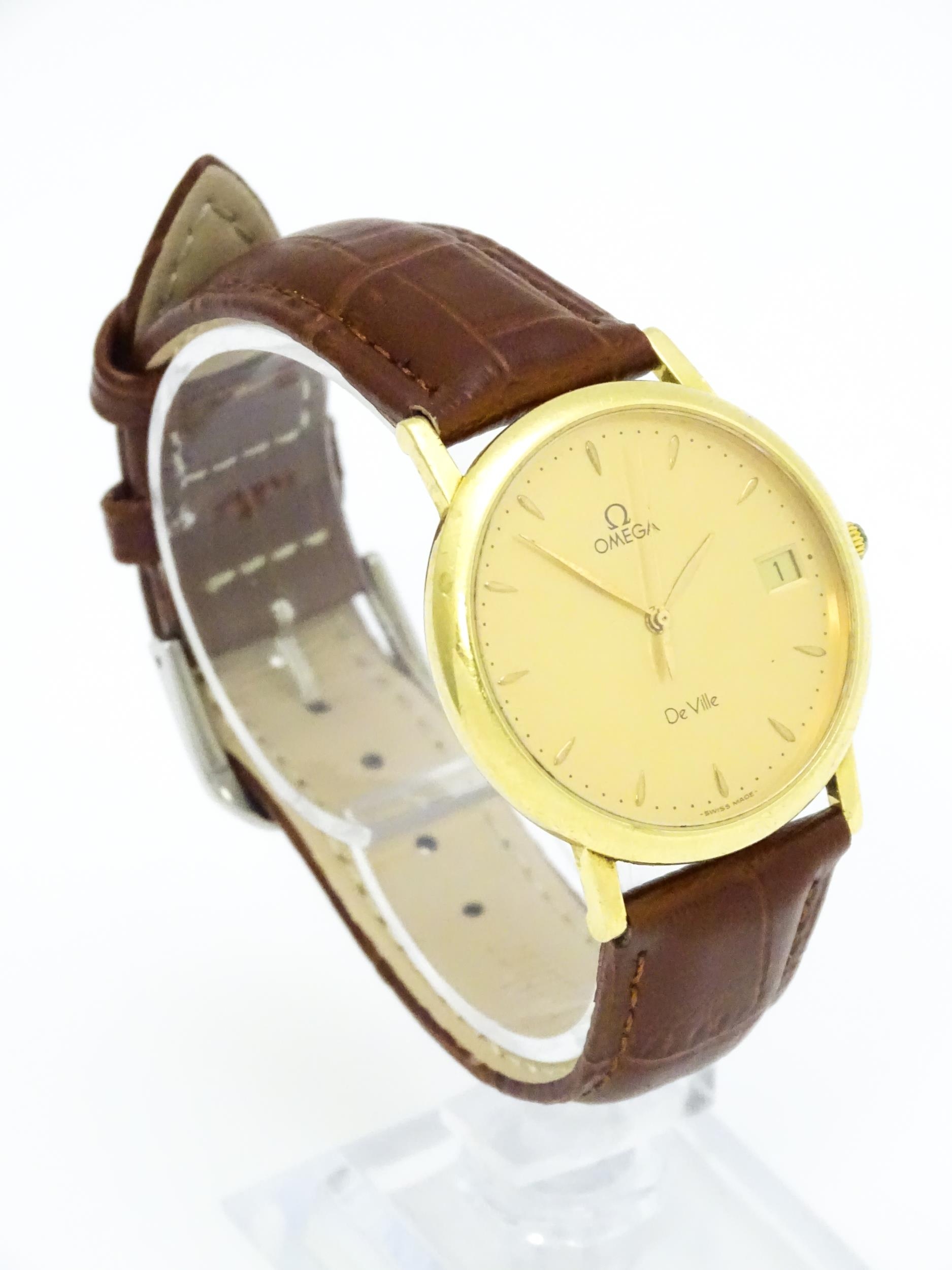 An Omega 18ct gold cased De Ville wristwatch, the dial with hour batons and date aperture. Watch