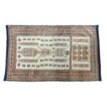 Carpet / Rug: A beige ground rug with repeated motifs worked in salmon pink, brown and beige, with