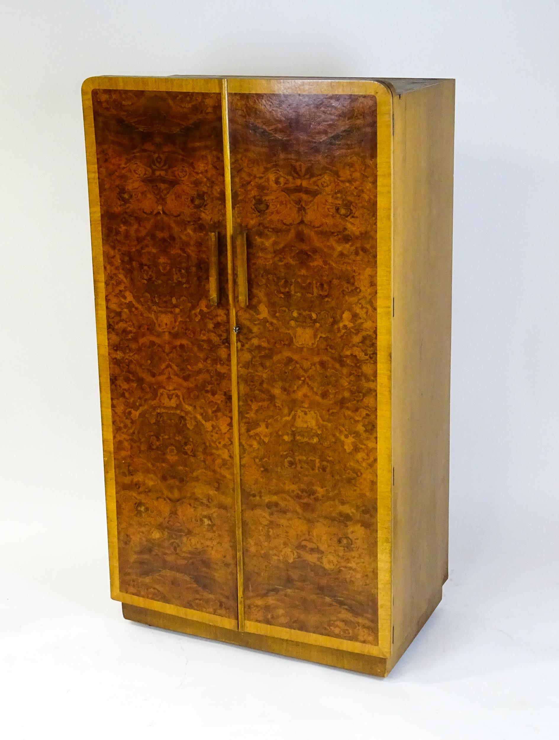 A mid 20thC Art Deco style wardrobe / cupboard with burr walnut veneered doors and shaped handles. - Image 5 of 7