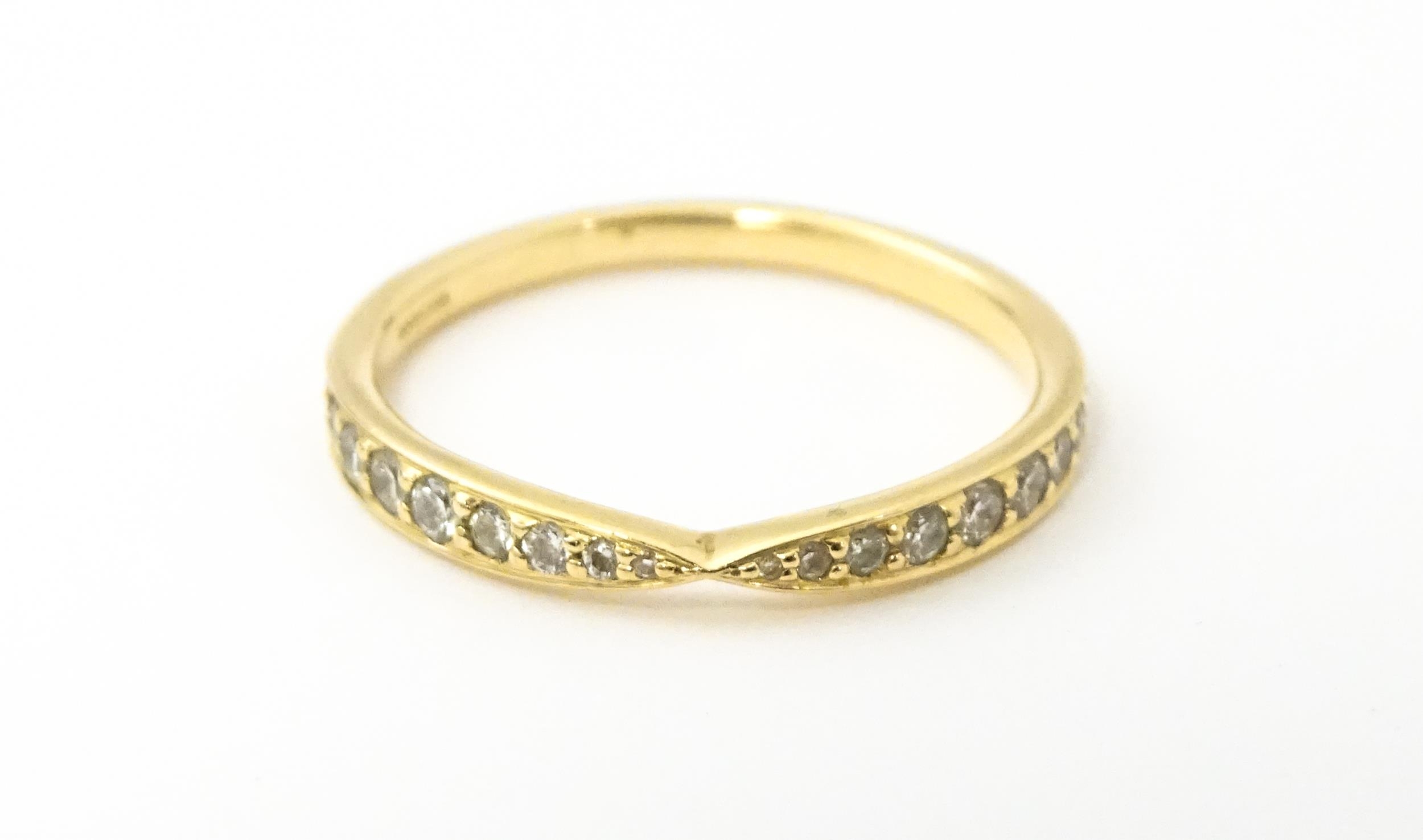 An 18ct gold Tiffany ring set with diamonds. Ring size approx M Please Note - we do not make