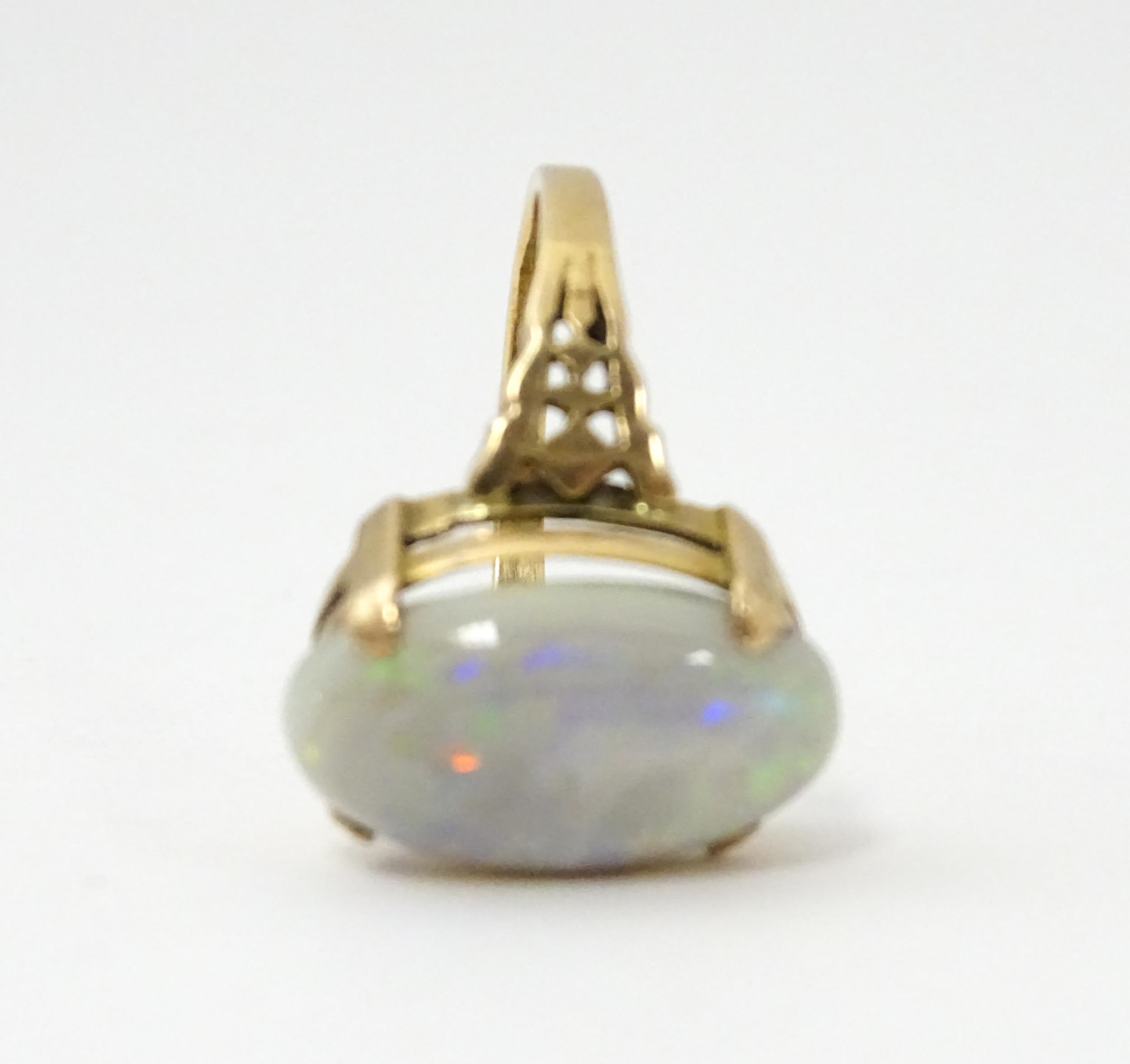 A 9ct gold ring set with large opal cabochon. The opal approx 3/4" long. Ring size approx. 0 - Image 10 of 10