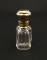 A French scent / perfume bottle with silver gilt top. Approx. 2 1/4" high Please Note - we do not