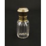 A French scent / perfume bottle with silver gilt top. Approx. 2 1/4" high Please Note - we do not