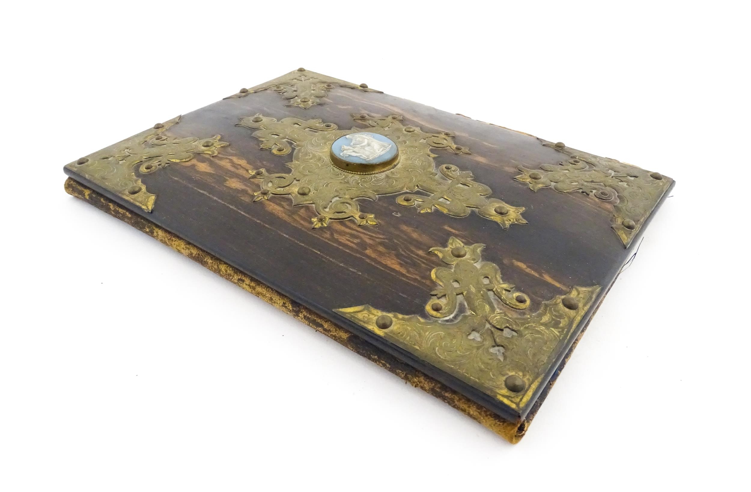 A Victorian blotter with coromandel front cover with decorative brass mounts and set with central