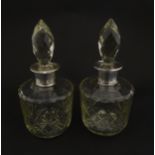 Two glass flasks formed as small cut glass decanters with Argentinian .925 silver mounts. Approx. 8"