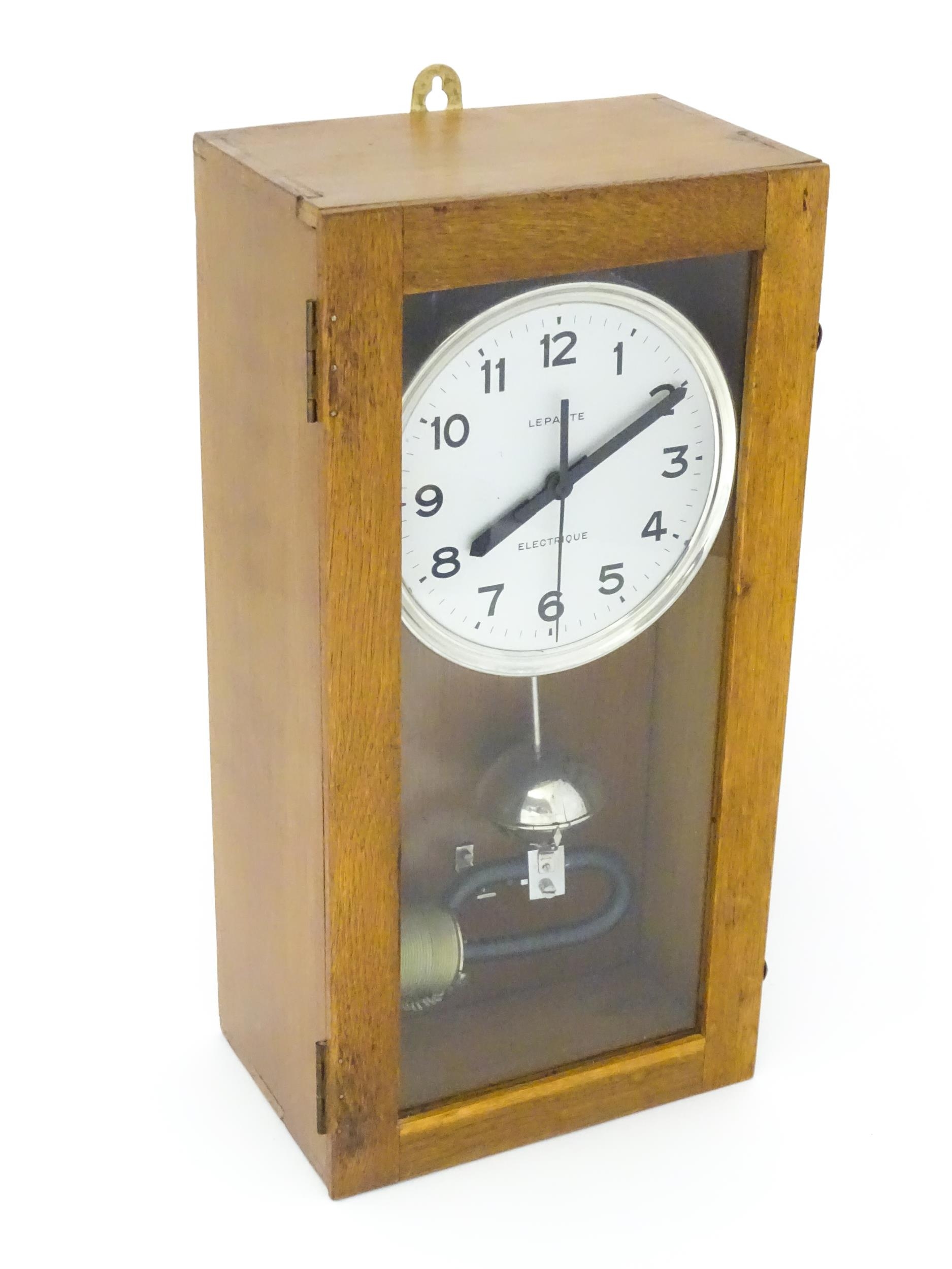 Lepaute : An early 20thC oak cased electric clock. The white dial with Arabic numerals signed - Image 4 of 6