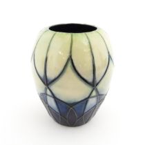 A Moorcroft vase of squat form decorated in the Indigo pattern designed by Emmas Bossons. Marked