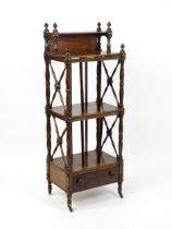 An early 19thC mahogany whatnot Canterbury surmounted by turned uprights and a small shelf above