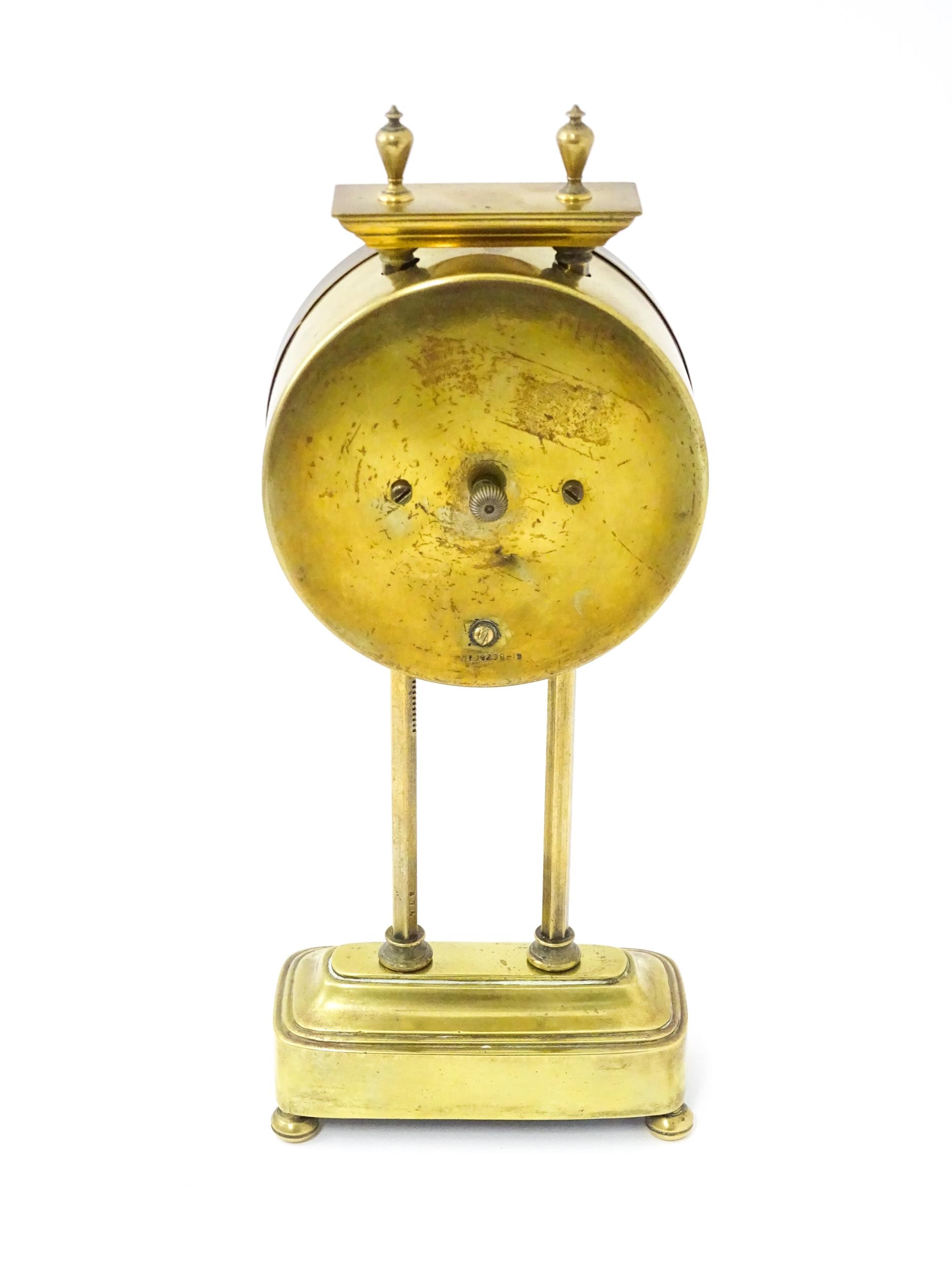 A brass cased Gravity clock with dial with Arabic numerals and having exposed escapement. Marked - Image 6 of 9