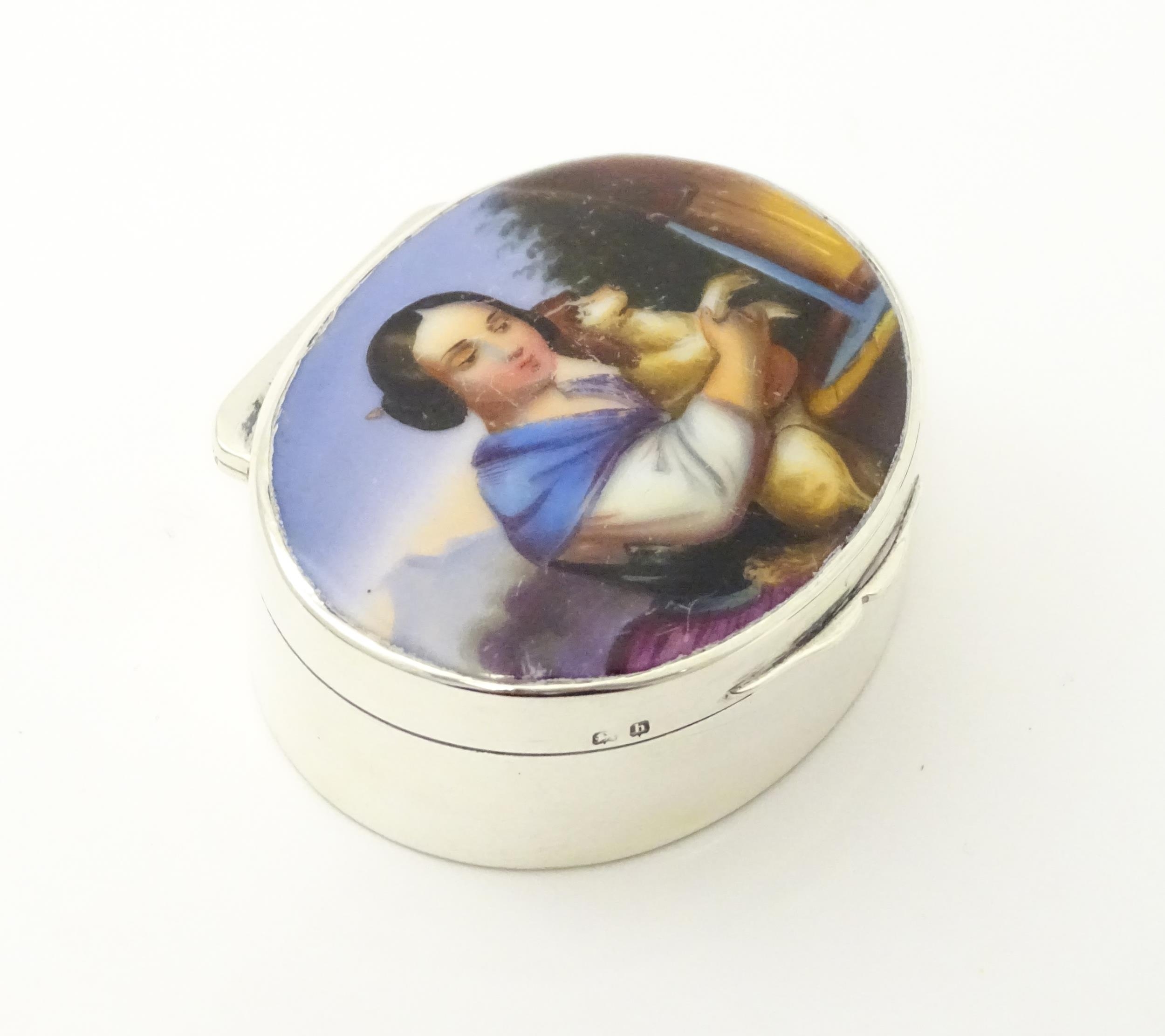 A silver pill box with gilded interior and ceramic cabochon to lid depicting a young girl holding - Image 4 of 9