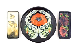 A Moorcroft plate decorated in the Poppy plate designed by Rachel Bishop. Together with two oblong