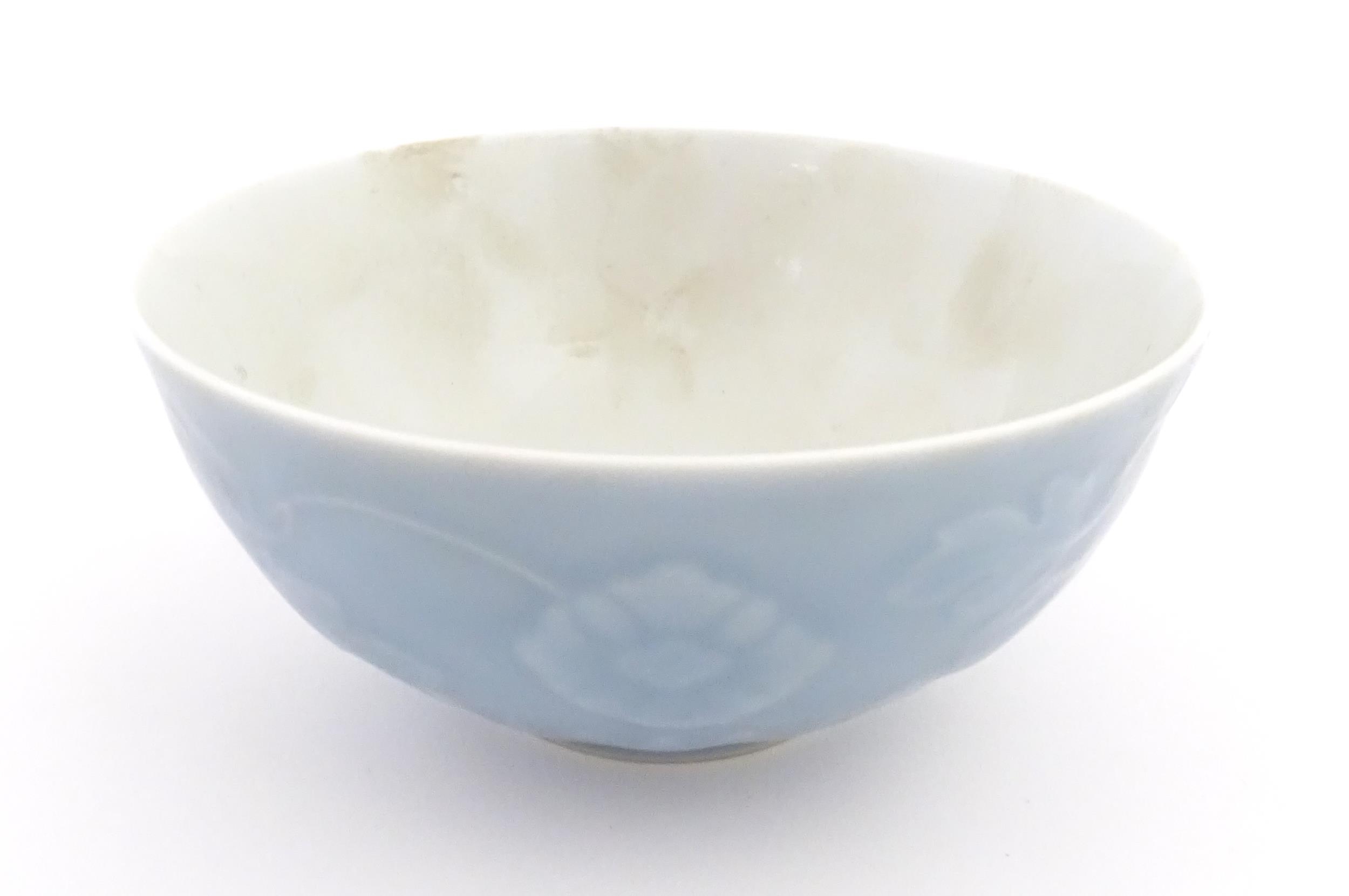 A Chinese bowl with a blue ground decorated with flowers and petals. Character marks under. - Image 4 of 8