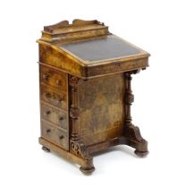A mid / late 19thC burr walnut Davenport surmounted by a fitted writing box above a leather slope,