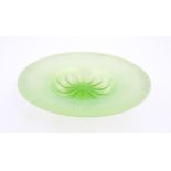 A pale green lustre glass bowl with lobed centre and textured rim. Approx. 12 1/2" diameter Please