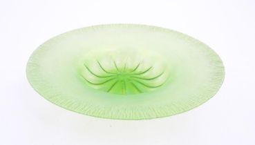 A pale green lustre glass bowl with lobed centre and textured rim. Approx. 12 1/2" diameter Please