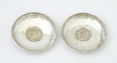 Two Hong King silver pin dishes set with Queen Elizabeth II 1975 one and two dollar coins. The