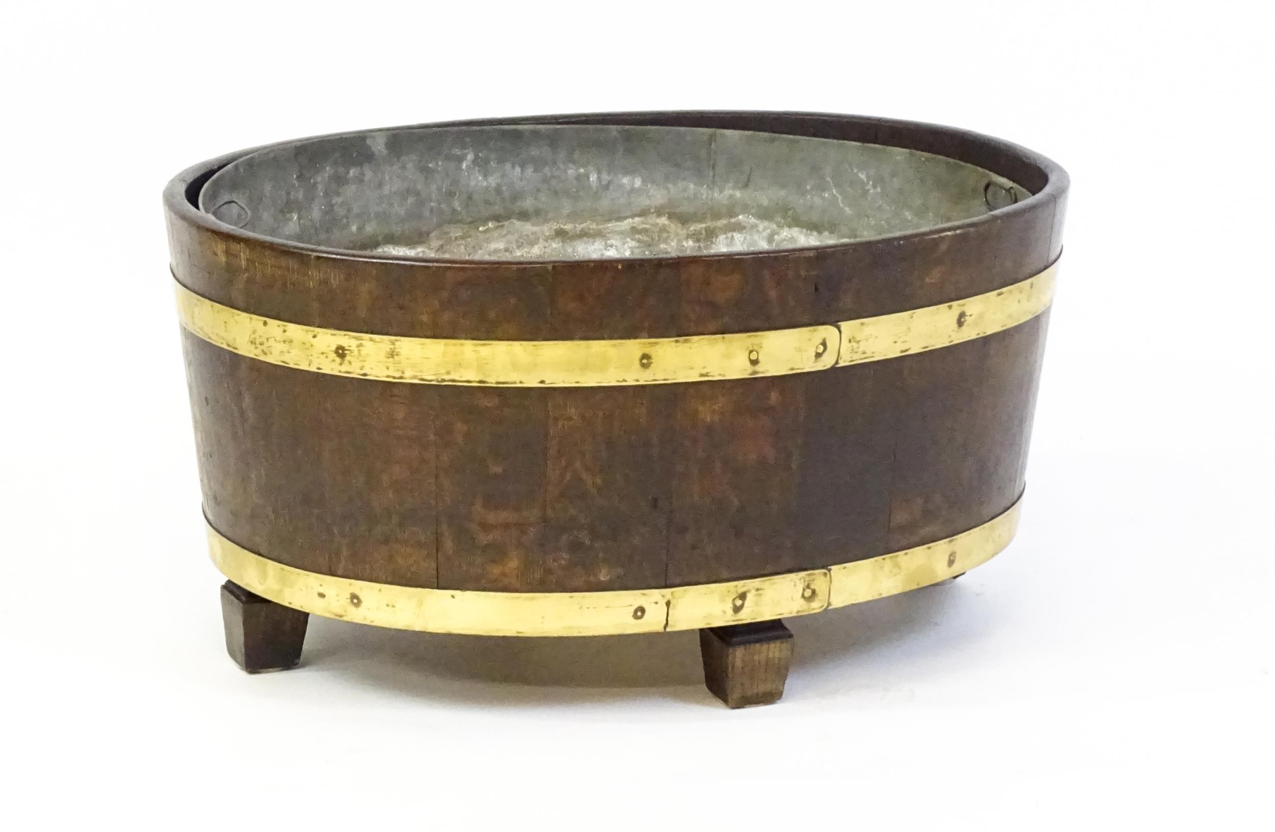 A late Georgian oak wine cooler / cellarette with a coopered and brass strapped frame and raised - Image 3 of 7