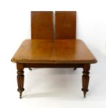 A 19thC mahogany dining table with a moulded top above turned, reeded and tapering legs