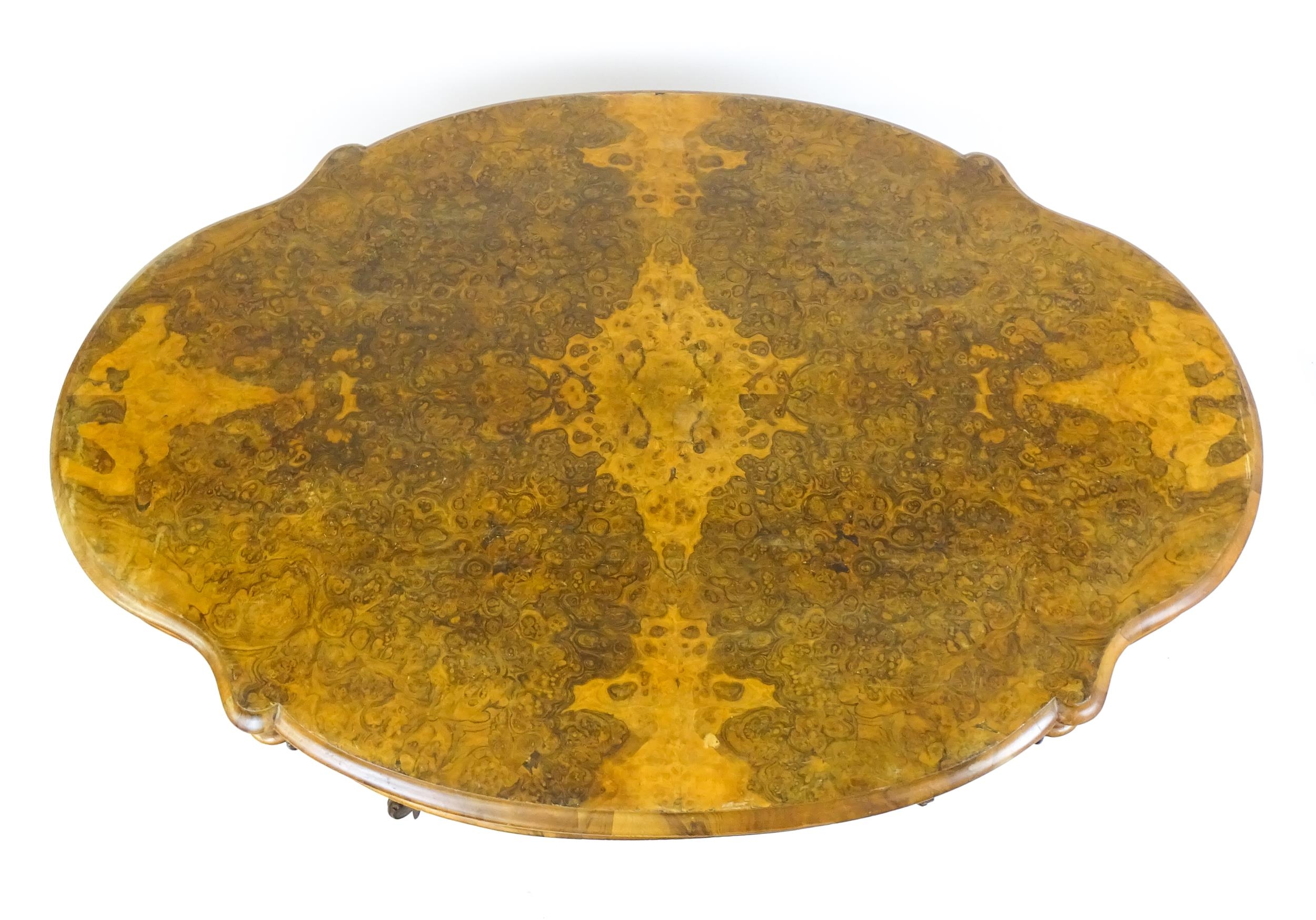 A 19thC burr walnut centre table with a moulded top above four acanthus carved supports, a large - Image 8 of 16