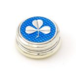 A silver patch / pill box with turquoise guilloche enamel decoration and applied clover detail,
