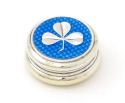 A silver patch / pill box with turquoise guilloche enamel decoration and applied clover detail,