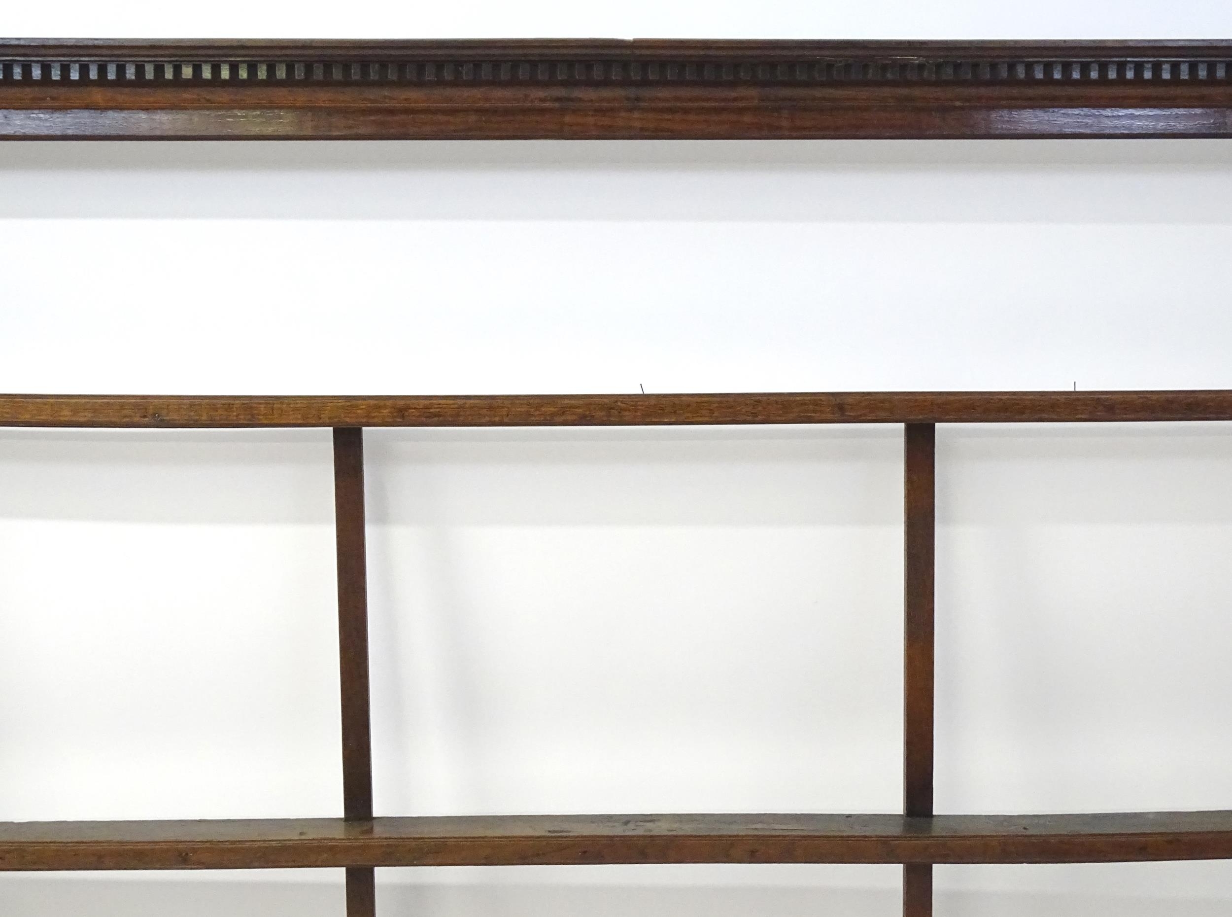 An 18thC oak plate rack with a dentil moulded frieze. 75" wide x 52" high. Please Note - we do not - Image 5 of 6