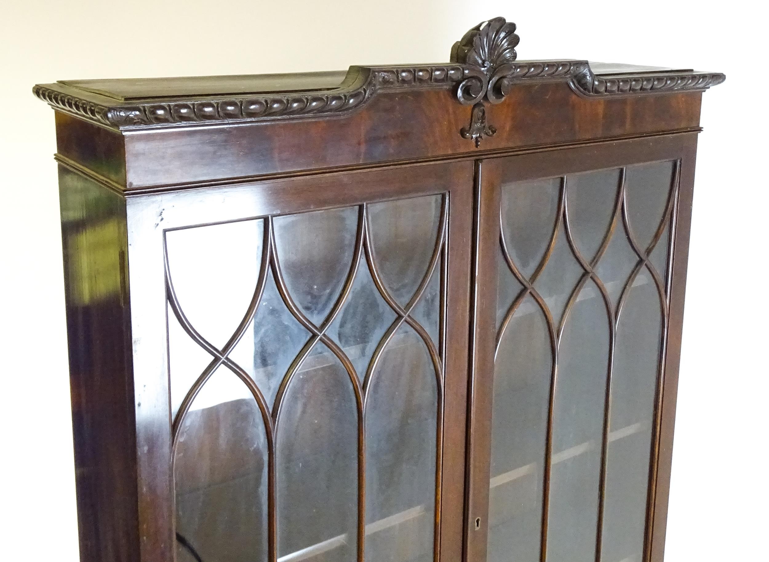 An early 20thC mahogany bureau bookcase with a carved cornice above two astragal glazed doors and - Image 3 of 6