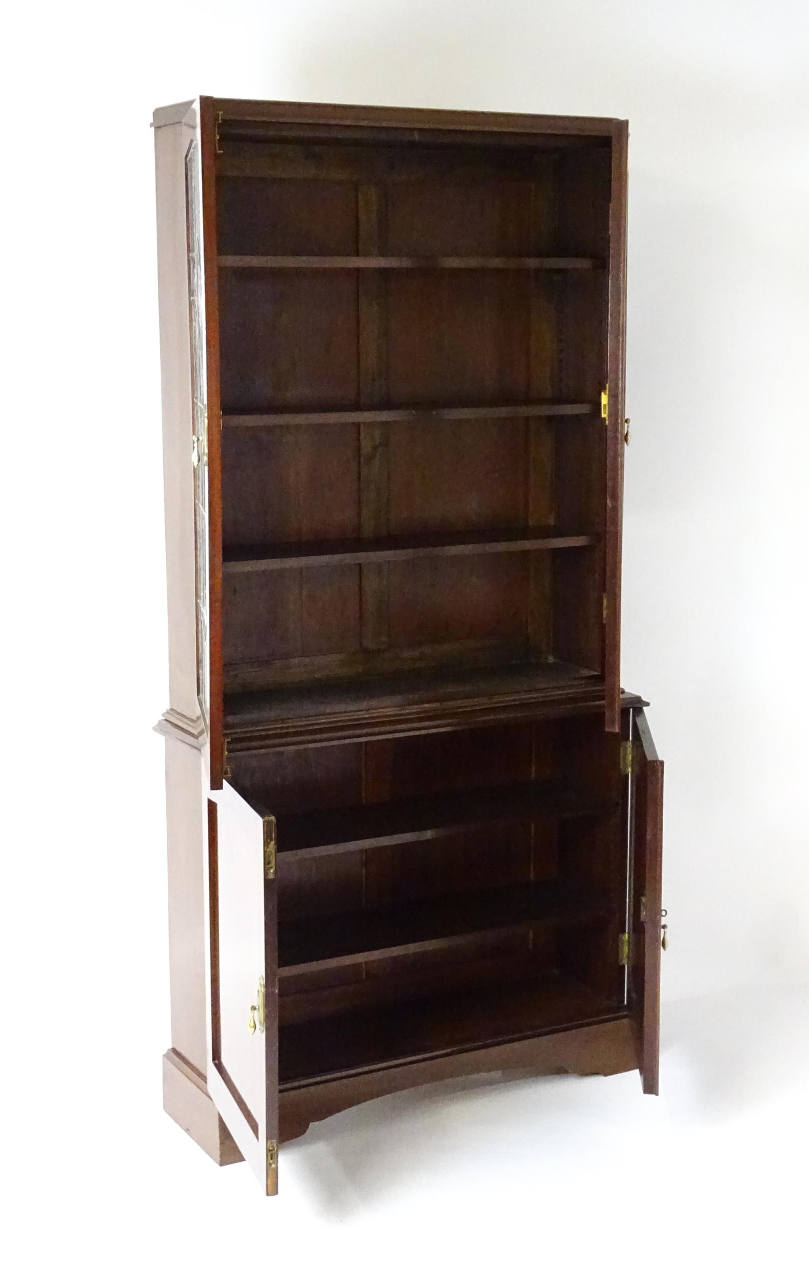 An early / mid 20thC mahogany bookcase with stained and leaded glass panels above two panelled - Image 2 of 4