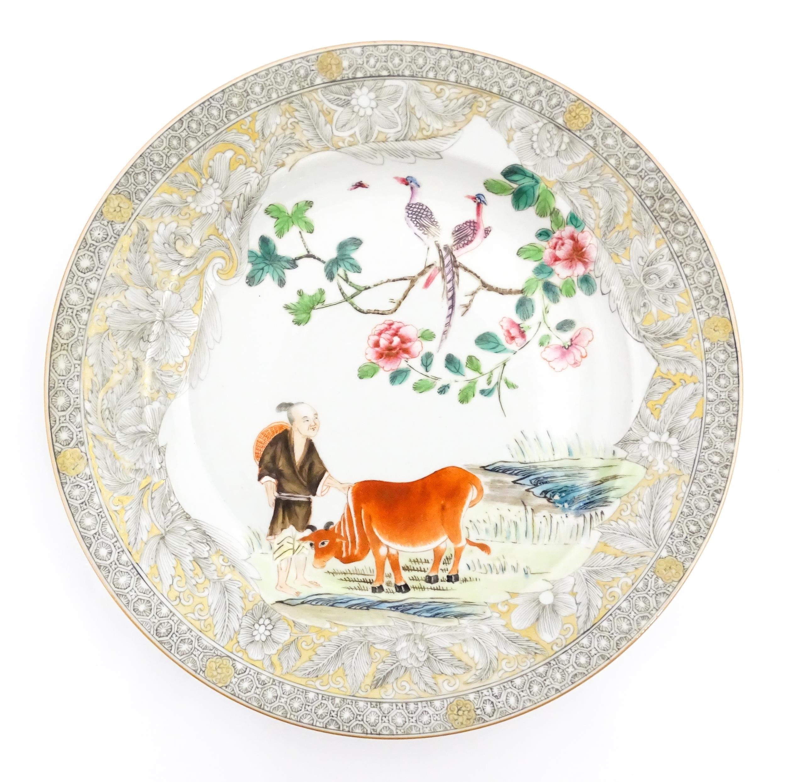 A Chinese export plate decorated with a figure, ox, birds and flowers in a landscape with - Image 2 of 3