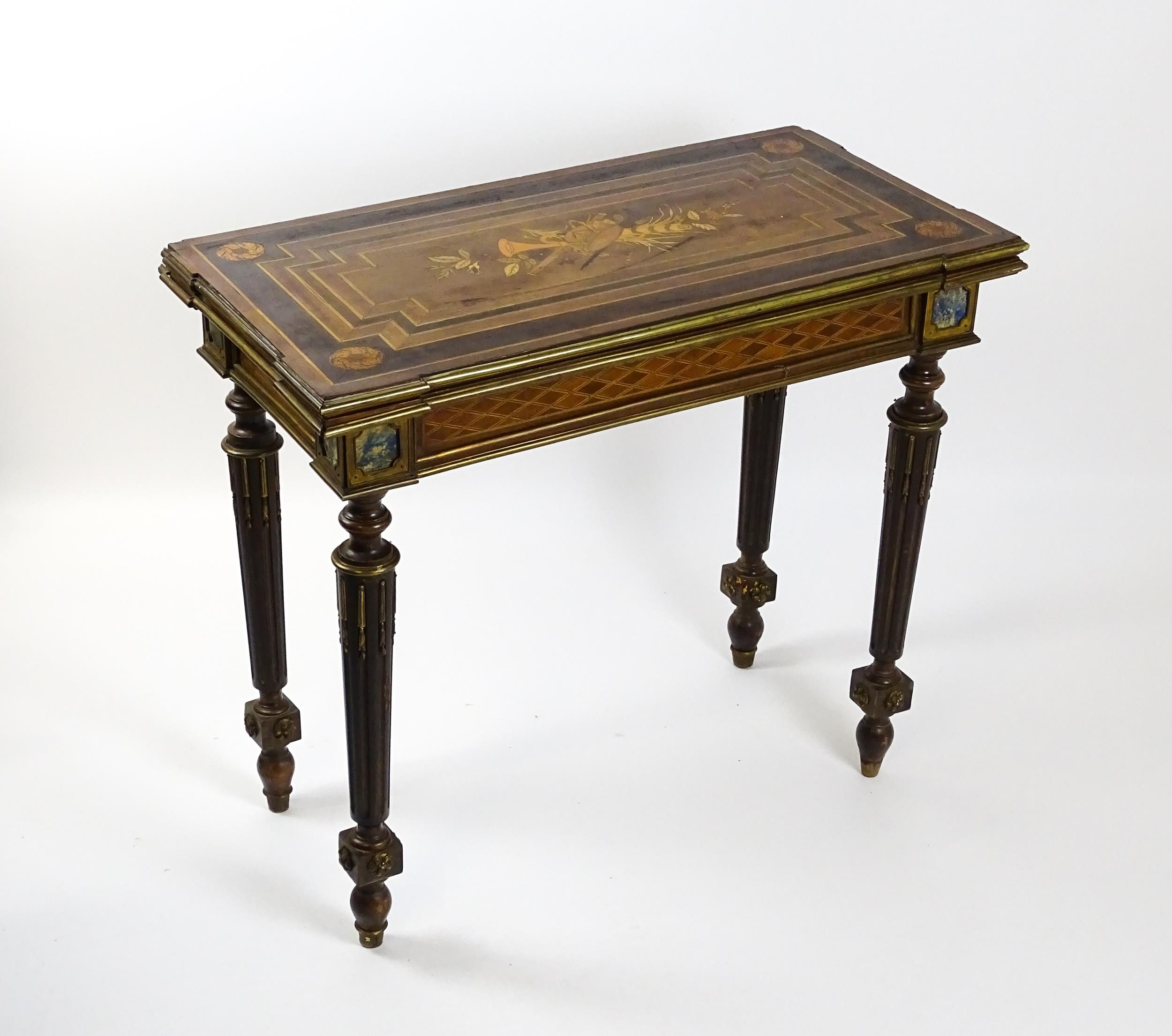 A 19thC card table with a marquetry inlaid cornucopia to the top and brass mouldings to the rim. The - Image 2 of 15