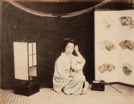 Japan. A seated young Japanese woman with a mirror, c. 1880