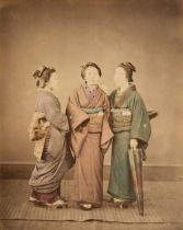 Japan. A group of 3 standing young women in traditional dress