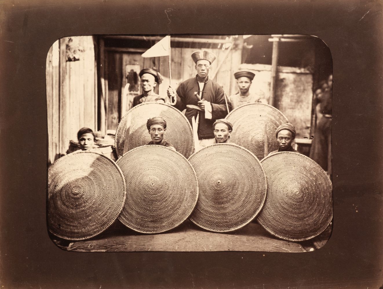 China. Courtyard with soldiers holding rattan shields and an official with his hand on his sword,