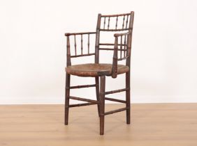 A STAINED BEECHWOOD SUSSEX CHAIR ATTRIBUTABLE TO FORD MADDOX BROWN