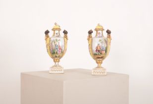 A PAIR OF 'HELENA WOLFSOHN' STYLE PORCELAIN TWO HANDLED URNS