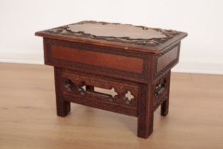 A CHINESE CARVED AND STAINED WOOD LOW FOLDING TABLE