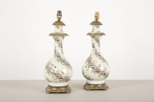 A PAIR OF PORCELAIN AND GILT METAL MOUNTED TABLE LAMPS