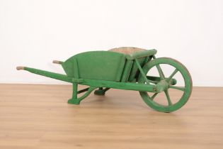 A VINTAGE GREEN-PAINTED WHEELBARROW