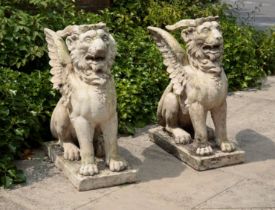 A PAIR OF COMPOSITE STONE GRIFFONS