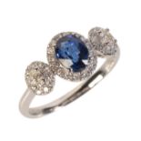 A SAPPHIRE AND DIAMOND THREE STONE RING