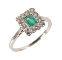 AN EMERALD AND DIAMOND CLUSTER RING