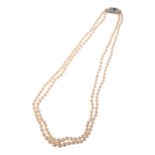 A VINTAGE SAPPHIRE AND DIAMOND TWO-ROW PEARL NECKLACE