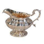 A GEORGE IV SILVER "MELON" SHAPED SAUCE BOAT