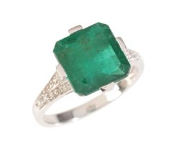 A 4.72 CARAT EMERALD AND DIAMOND RING