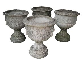 A SET OF FOUR RECONSTITUTED STONE NEO-CLASSICAL URNS