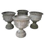 A SET OF FOUR RECONSTITUTED STONE NEO-CLASSICAL URNS